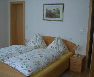 a bedroom with a bed and a picture on the wall at Haus Bauer Appartment II mit Balkon in Mariapfarr