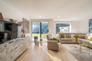 a living room with a couch and a tv at Villa Green - Sardegna in Calangianus