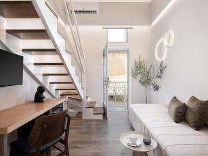 a living room with a white couch and stairs at Elia Erato in Chania