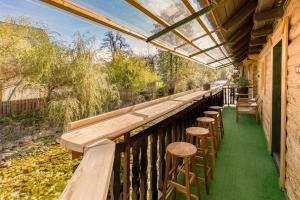 a row of wooden stools on a balcony at Captain's Lodge in Bohinj