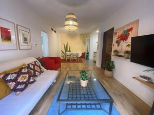 a living room with a couch and a coffee table at ROMANTICO APARTAMENTO SEVILLA in Seville