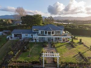 an aerial view of a house with a garden at RIDGETON in Aongatete