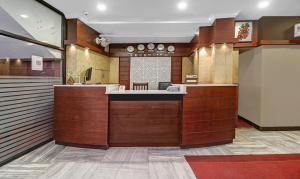 a lobby with a counter in a building at Treebo Trend Darwesh Residency in Kozhikode