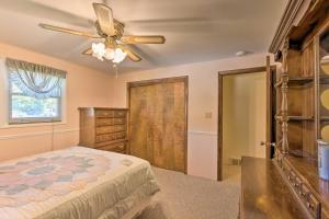 a bedroom with a bed and a ceiling fan at Lakefront Ludington Retreat with Kayaks and Fire Pit! in Ludington