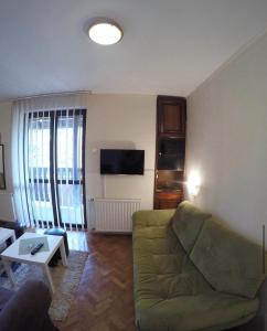 a living room with a couch and a table at Marija in Zlatibor