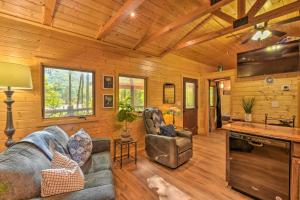 a living room with a couch and chairs in a cabin at Clayton Retreat with Spacious Deck and Mtn Views! in Clayton