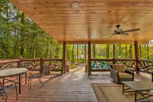 a wooden deck with a ceiling fan and tables and chairs at Clayton Retreat with Spacious Deck and Mtn Views! in Clayton