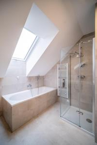 a bathroom with a shower and a bath tub at Holiday House U Hájenky 13P Lipno Home in Lipno nad Vltavou +50 photos