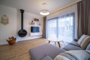 a living room with a couch and a table at Holiday House U Hájenky 13P Lipno Home in Lipno nad Vltavou