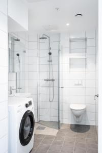 a bathroom with a washing machine and a toilet at Frogner House - Uranienborg in Oslo