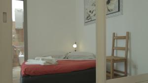 a bedroom with a bed with a ladder and a mirror at Casa Stefano Lecce in Lecce