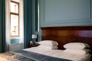 Postel nebo postele na pokoji v ubytování Leopolis Hotel