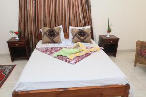 una cama con dos animales de peluche sobre ella en Masa House, en Luxor