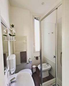 a white bathroom with a toilet and a sink at Amio Apartment - next to M5 Ca Granda in Milan