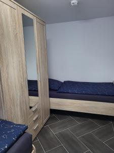 a room with a mirror and a futon at Gästewohnung 2 in Oschersleben