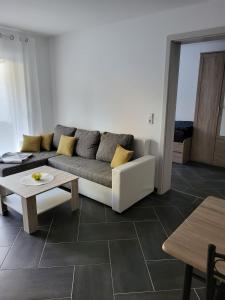 a living room with a couch and a table at Gästewohnung 2 in Oschersleben