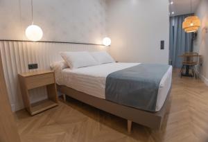 Posteľ alebo postele v izbe v ubytovaní OIKOS APARTAMENTOS TURÍSTICOS