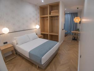 Posteľ alebo postele v izbe v ubytovaní OIKOS APARTAMENTOS TURÍSTICOS