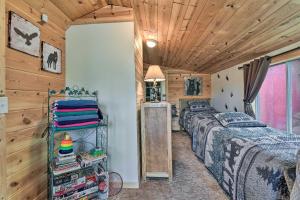 Schlafzimmer mit 3 Betten und Holzdecke in der Unterkunft Charming Gladwin Family Cottage - Indian Lake in Gladwin