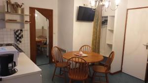 a kitchen with a table and chairs in a kitchen at Au Relais Des Thermes in Saint-Amand-les-Eaux