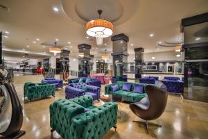 a lobby with couches and chairs in a mall at Nashira City Resort Hotel in Antalya