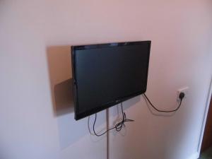 a flat screen tv hanging on a wall at The Sandhill in Sandown