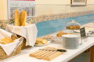 a buffet with bread and pastries on a counter at Hotel Atalaya I in Portonovo