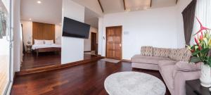 a living room filled with furniture and a tv at Twin Bay Resort - SHA Extra Plus in Ko Lanta
