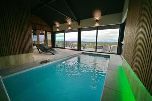 a swimming pool in a house with a view of the ocean at Ard'view in Durbuy
