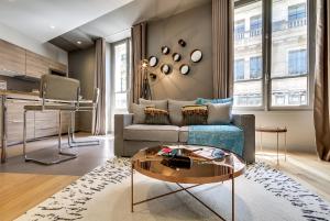 salon z kanapą i stołem w obiekcie Sweett - Parisian Allure w Paryżu