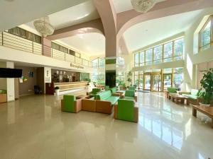 a lobby with couches and chairs in a building at Palma Hotel in Golden Sands +34 photos