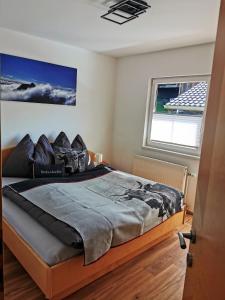 a bedroom with a bed in a room with a window at Ferienhaus Gschlössl in Rauris