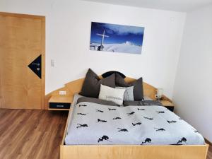 a bedroom with a bed with a cross on the wall at Ferienhaus Gschlössl in Rauris