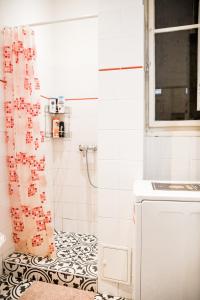 a bathroom with a shower curtain and a sink at Stylish and Spacious ! Central location Kazincy Netflix in Budapest