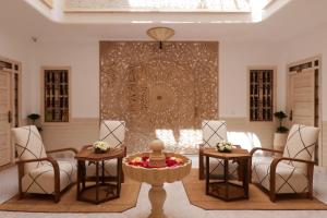 a living room with two chairs and a table at Riad Wazani Square & SPA in Marrakech