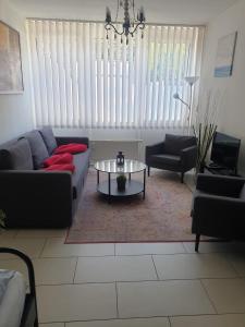 a living room with a couch and a table at Düsseldorf Comfort Apartment in Düsseldorf