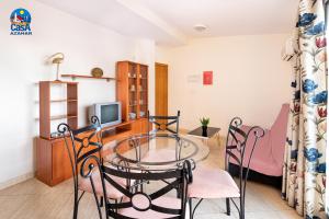 a dining room with a glass table and chairs at Residencial Marcomar Casa Azahar in Alcossebre