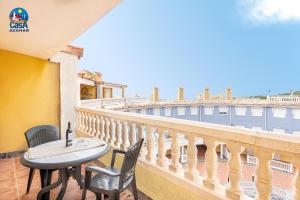 a balcony with a table and chairs and a view at Residencial Marcomar Casa Azahar in Alcossebre