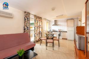 a living room with a couch and a table at Residencial Marcomar Casa Azahar in Alcossebre