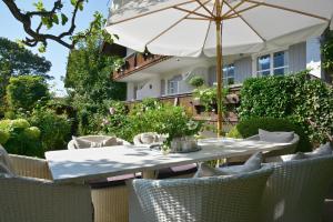 een tafel en stoelen met een parasol op een patio bij Haus Katrin in Bad Hindelang