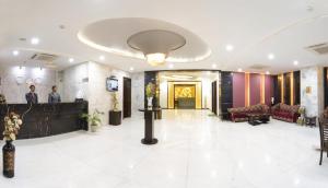 a lobby of a hotel with people standing in it at Hotel Crimson Palace in Agra