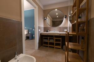 a bathroom with a sink and a mirror at Tenuta Tre Gemme a Mare - Suite Blu Vista mare in Pescara +9 photos