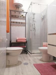 a bathroom with a shower and a toilet and a sink at Casa Vacanze VITTORIA in Taranto
