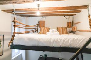 a bedroom with a wooden bed with towels on it at Esprit Feydeau- 2 chambres en bail mobilité in Nantes