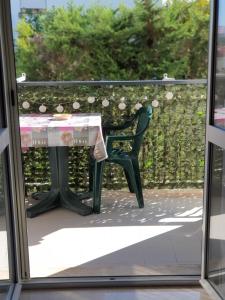 a table and a chair outside a window at Le case di Grazia in Gaeta