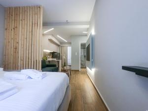 a hotel room with a bed and a tv at Elegant Suite - Piraeus in Piraeus