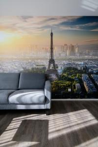 a living room with a couch and the eiffel tower at Smart & Stay Aparthotel Saarbrücken Süd - Self-Check-In - Free Parking in Saarbrücken