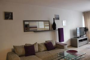 a living room with a couch and a mirror at C056-Cannes Rue Antibes - Studio in Cannes