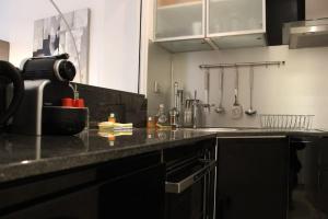 a kitchen with a black counter top in a kitchen at C056-Cannes Rue Antibes - Studio in Cannes