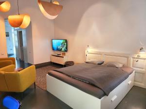 a bedroom with a large bed and a television at Stylish holiday Art apartment - wifi & great location in Budapest